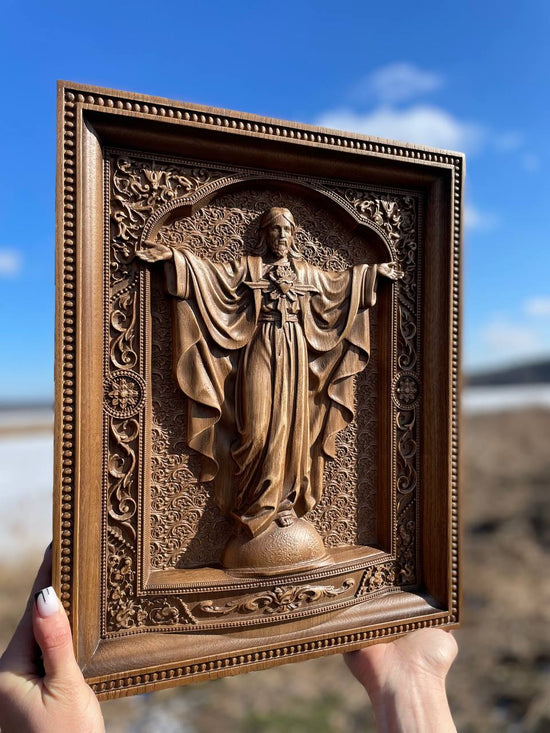 Wooden icon of the Sacred Heart Jesus arms extended